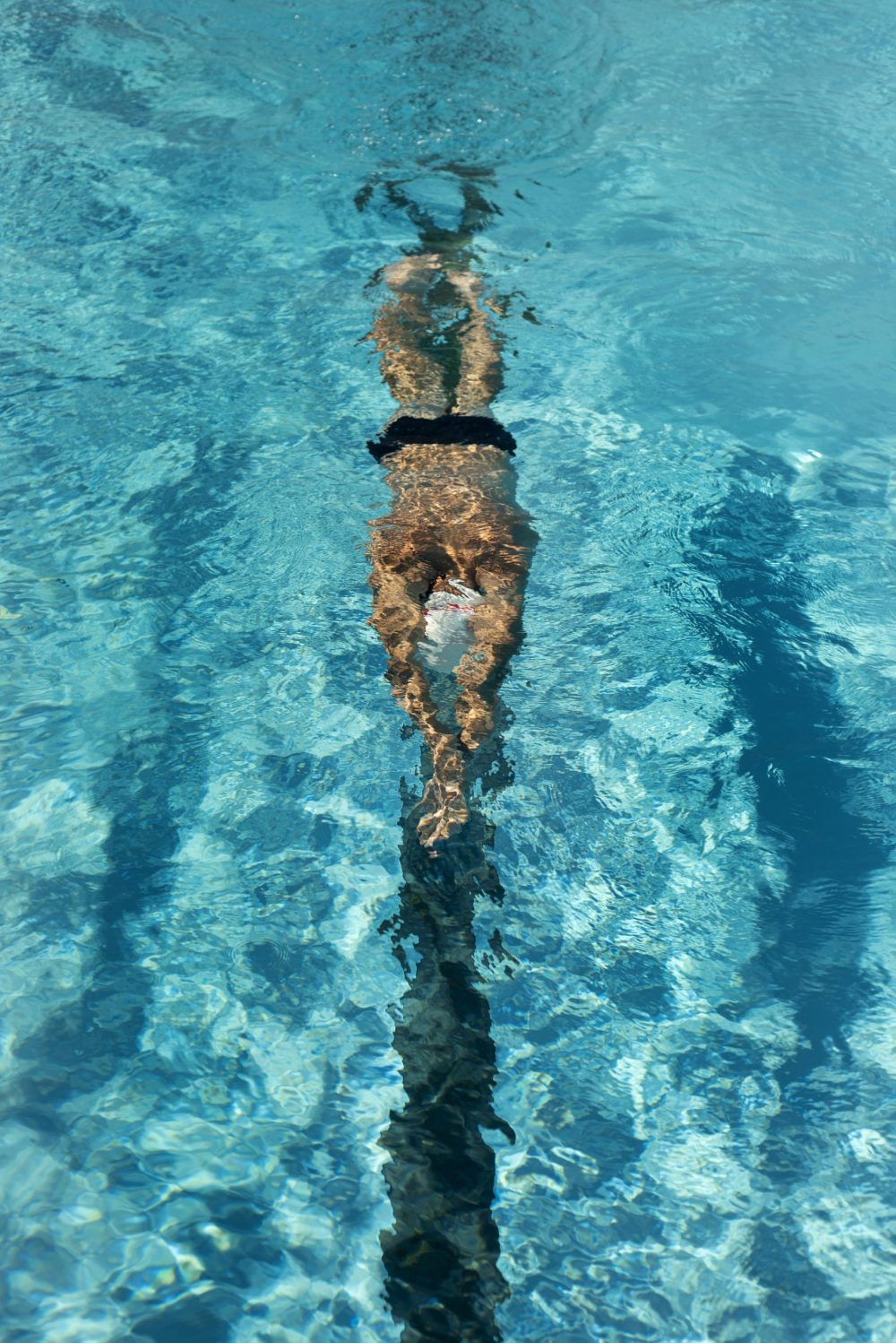 high-angle-male-swimmer-swimming-water-pool